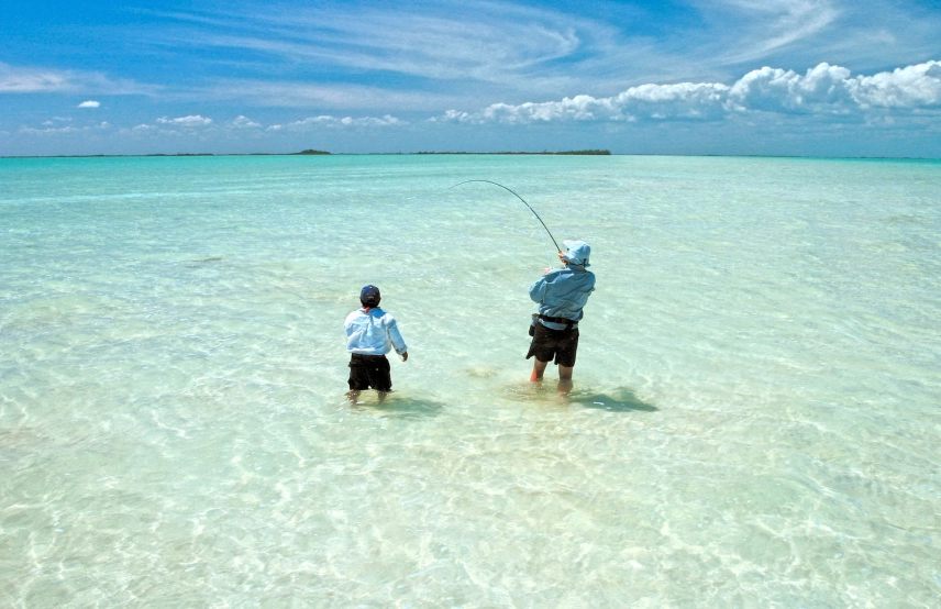 Guide and angler on the bonefish flats Guide and angler on the bonefish flats
