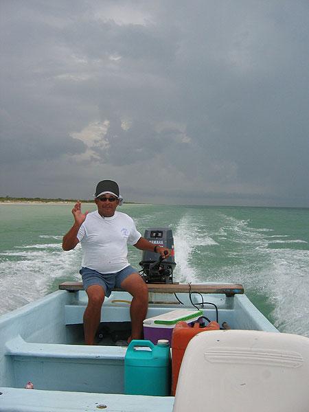 Chino - Our guide for most of the days: Chino. A really nice guy, an excellent tarpon spotter and very good at the pole - which is quite important when fishing the shallow mangrove waters.
As you may be able to see we are trying to escape a heavy shower behind us.