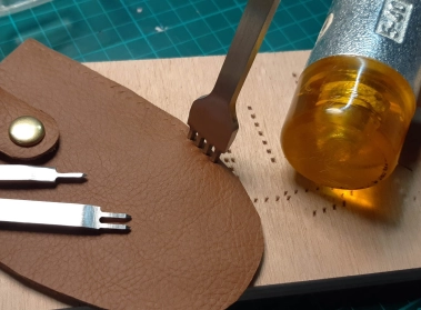 Making the stitching holes with a stitching chisel Making the stitching holes with a stitching chisel