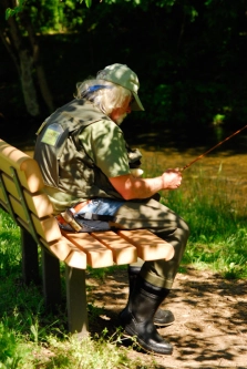 Angler checking gear. Yellow Breeches, PA Angler checking gear. Yellow Breeches, PA