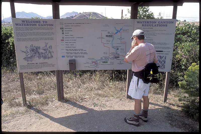 Sign - Steve reading the sign describing the Waterton Canyon stream.