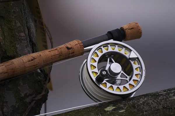 Just a reel - A Scierra Traxion rests on a fence by the water.