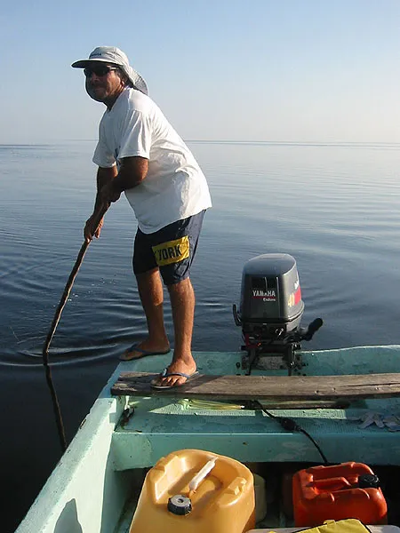Carlos - Carlos poling in the calm water after a thunder shower in the mangrove.