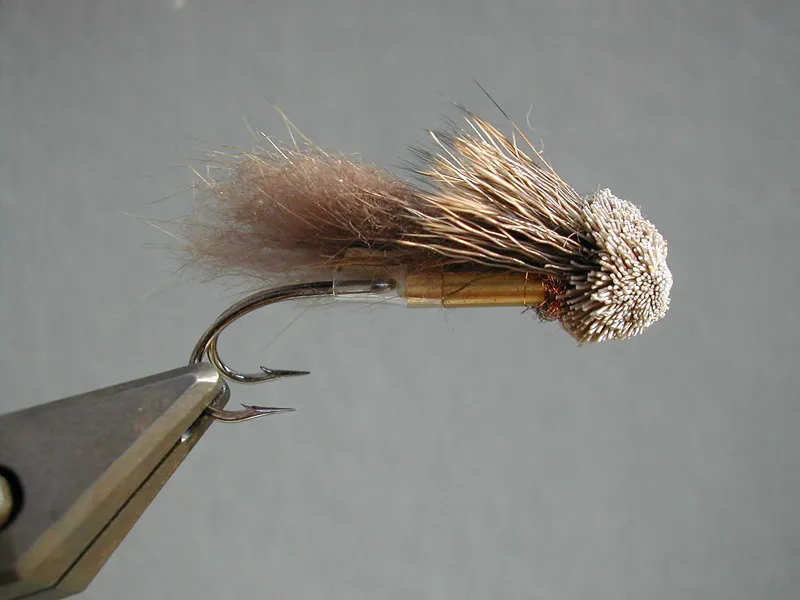 SHCZCDNTM - The Short Heavy Chicago-Zürich-Copenhagen Delayed Nutria Tube Muddler is a variation of a pattern I have tied for many years in all kinds of styles.
