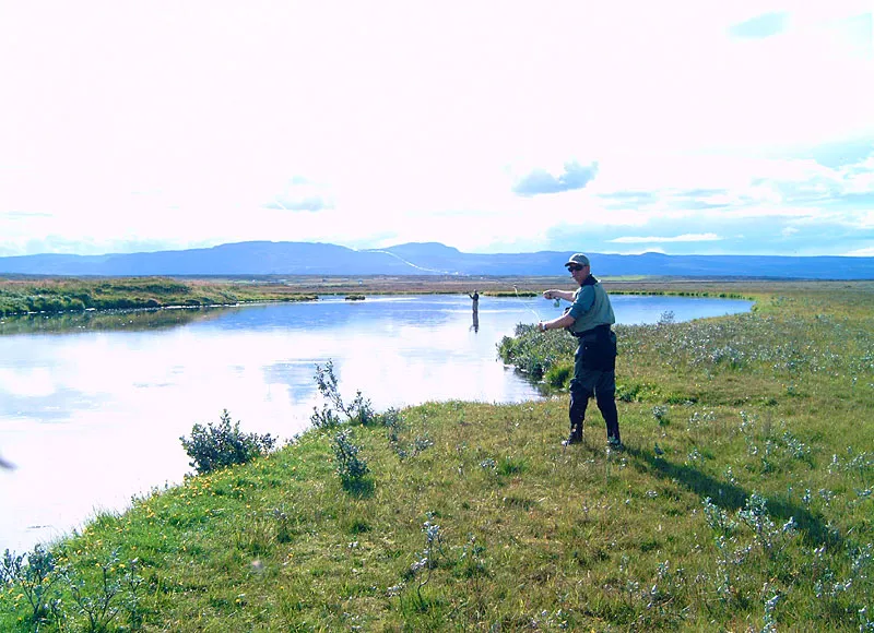 Ruined - This slide is a lost case. The angler, the grass and even the mountains in the background may be well exposed, but the sky is totally ruined due to too much light