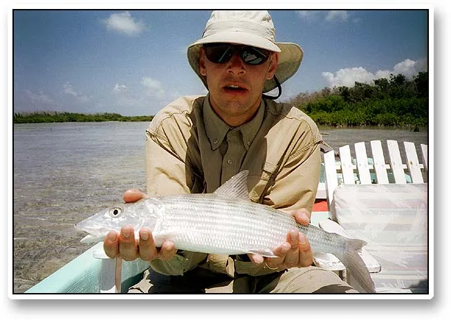 Joachim with a bonefish - Joachim presenting a bonefish before it is released back to the freedom of the Ambergris flats.