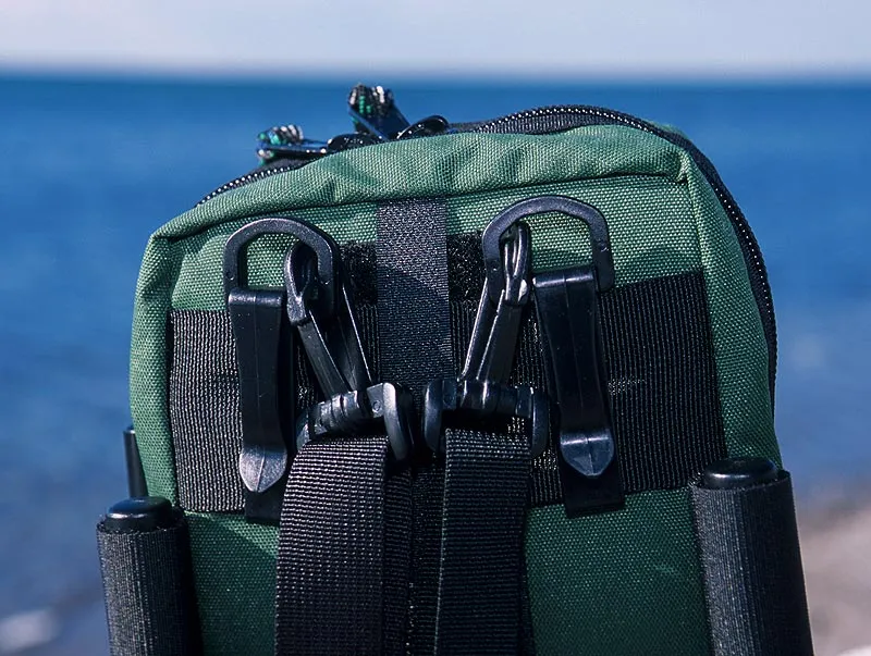JW Outfitters back - The clip system on the JW Outfitters pack is lousy to put it mildly. While the thought is OK, the final result is not. The clips are too soft in warm weather and too brittle in cold. One clip has broken since this photo was taken, and both straps have been lost several times because they just fall off.