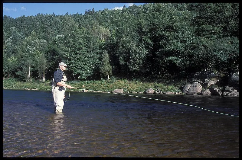 Anxiously waiting - Every cast is made in expectation of a fish. Watching the line sweep downstream becomes almost like meditation after a long day of fishing.