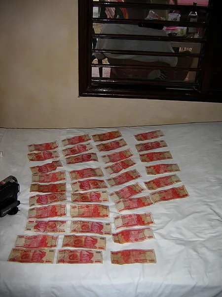 Money laundering - I didn't want to take pictures in the heavy rain, but we were wet to the skin - as was our money, here put out to dry on the bed.