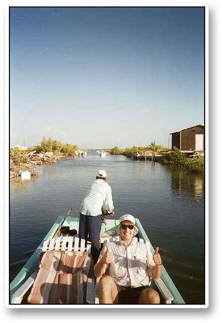 Ready to go! - More than ready to go, Kristian happily signals OK to Joachim while Ramon backs the boat out of the canal behind our resort where we were picked up early every morning.