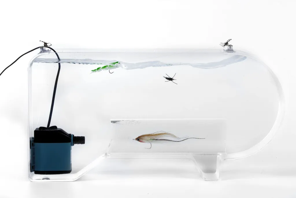 Flymen Fly Tester - A transparent tank with a current