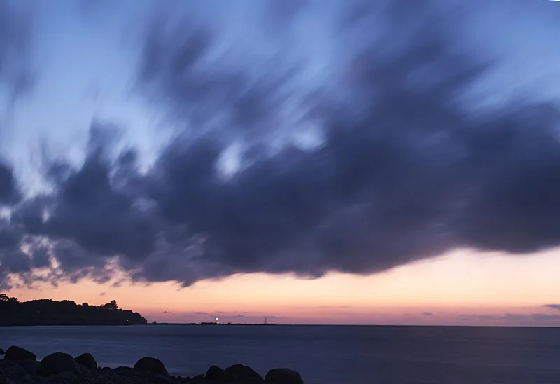 Slow shutter - This picture was done late at in the light Scandinavian night. Using a rock for support and a shutter speed of 10 seconds I was able to get the light and the drama of the clouds. The long shutter opening meant that the clouds moved while exposed, which is why they are blurred.