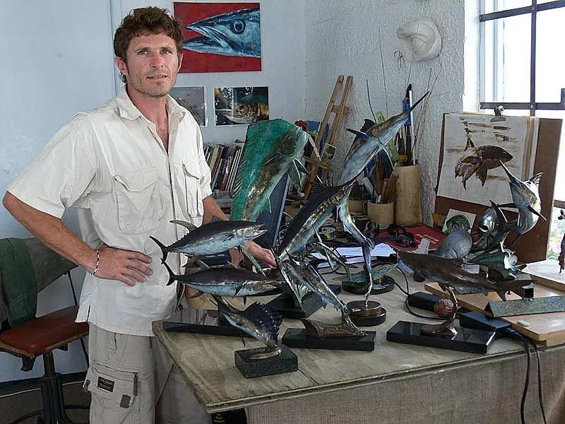 The artist and his work - Chris Bladen by some of his many fish statuettes