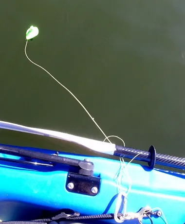 Latching it - The smallish floating RF unit can be attached to a stout fly line and cast out or it can be tethered to a float tube or small boat. Here, it is tethered with an old 5-wt fly line and a caribiner to the side of a kayak.