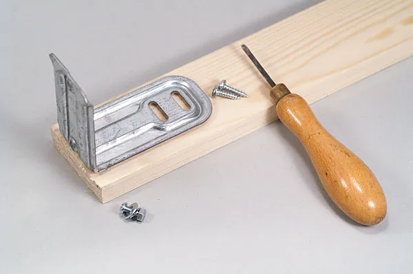 Wood and iron - You need a small piece of scrap wood. About 5x25 centimetres or 2x10 inches should do. Make sure you have short screws for wood and a short bolt to mount the motor.