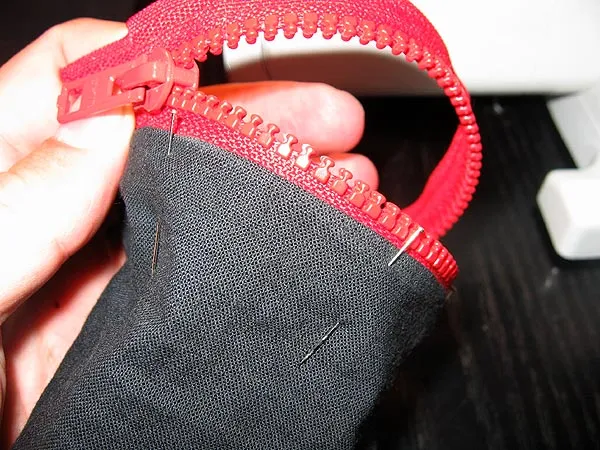 Zipper - I chose to sew on the zippers to the already closed sock. Here I attach one half with needles.